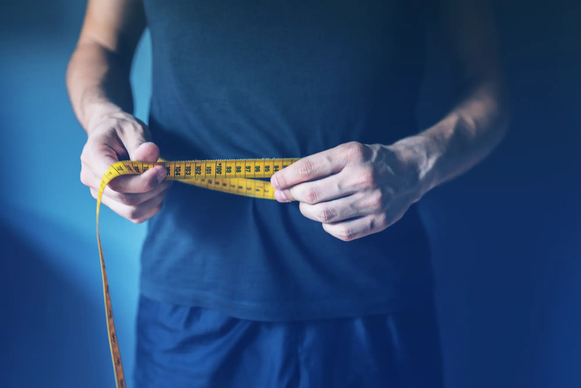 Man measuring waist