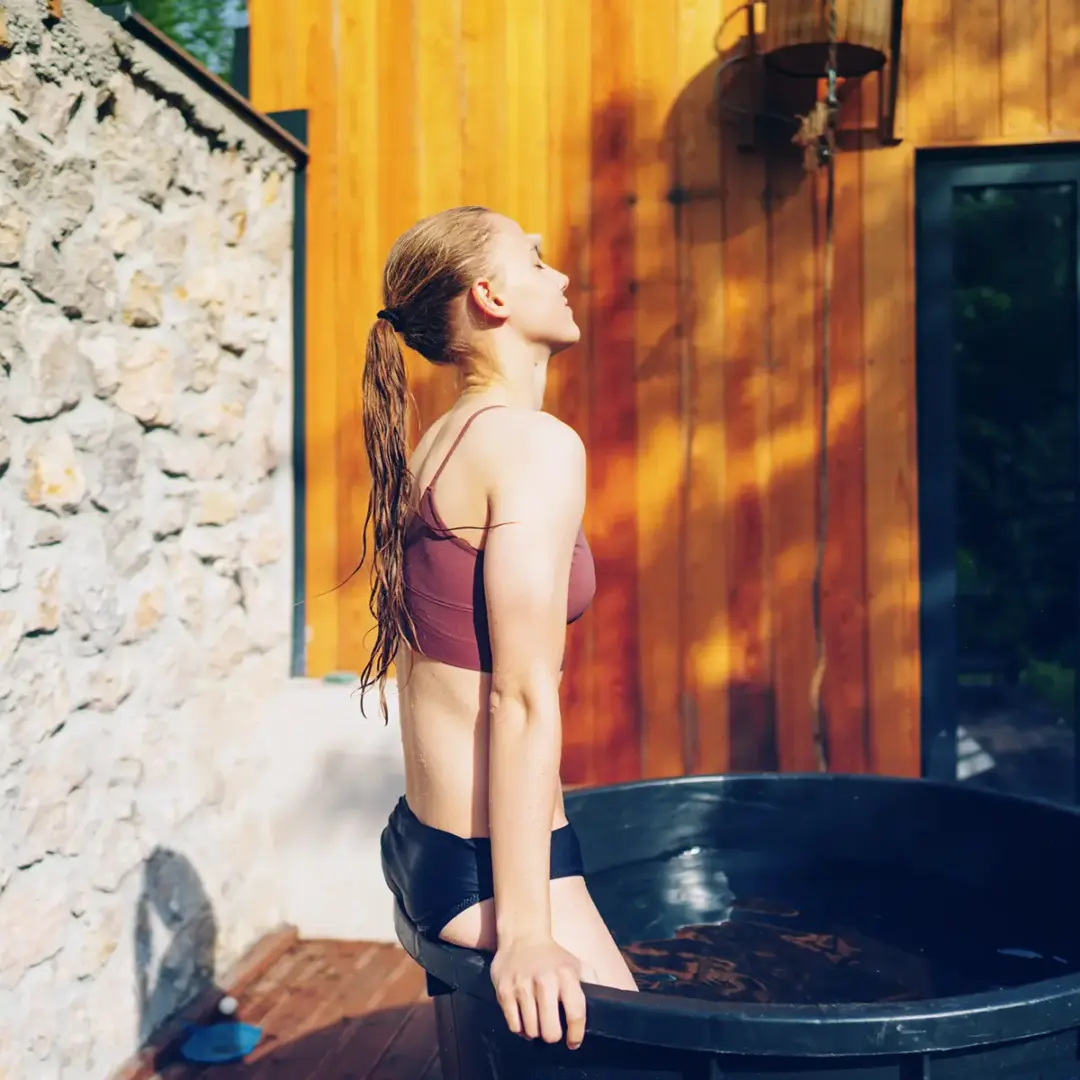 woman getting into ice bath