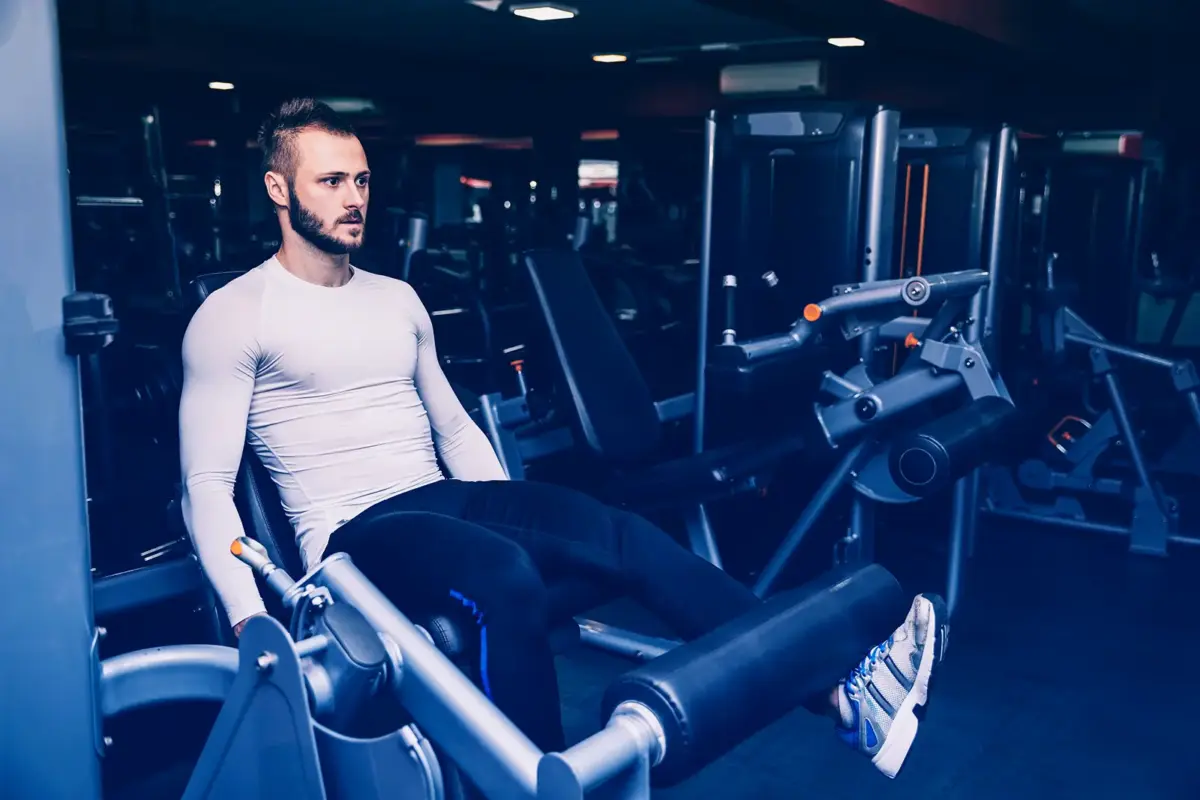 man doing leg extensions