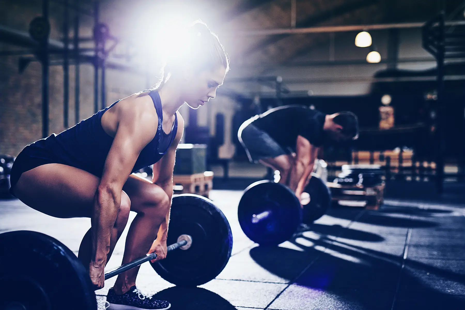 man and woman doing deadlifts