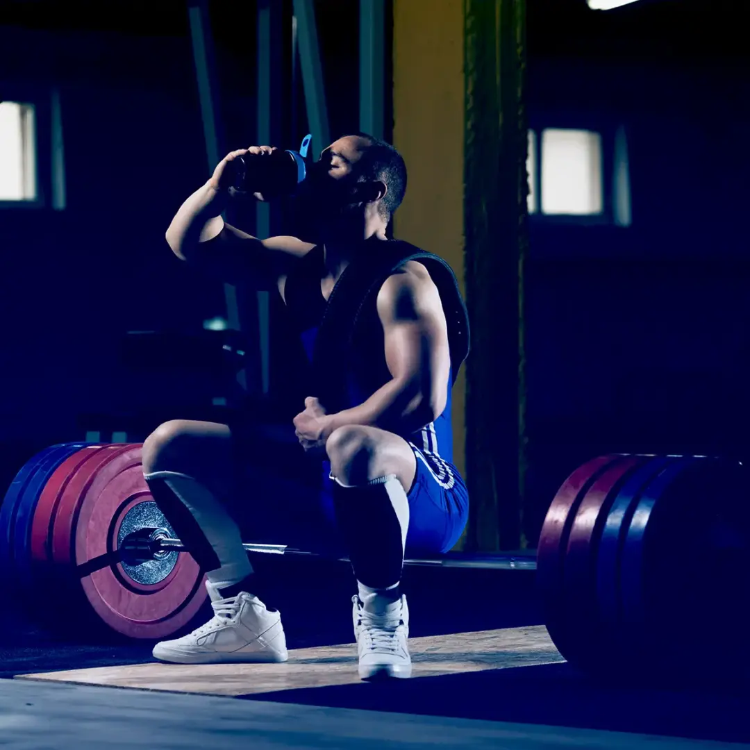 man drinking coffee at gym