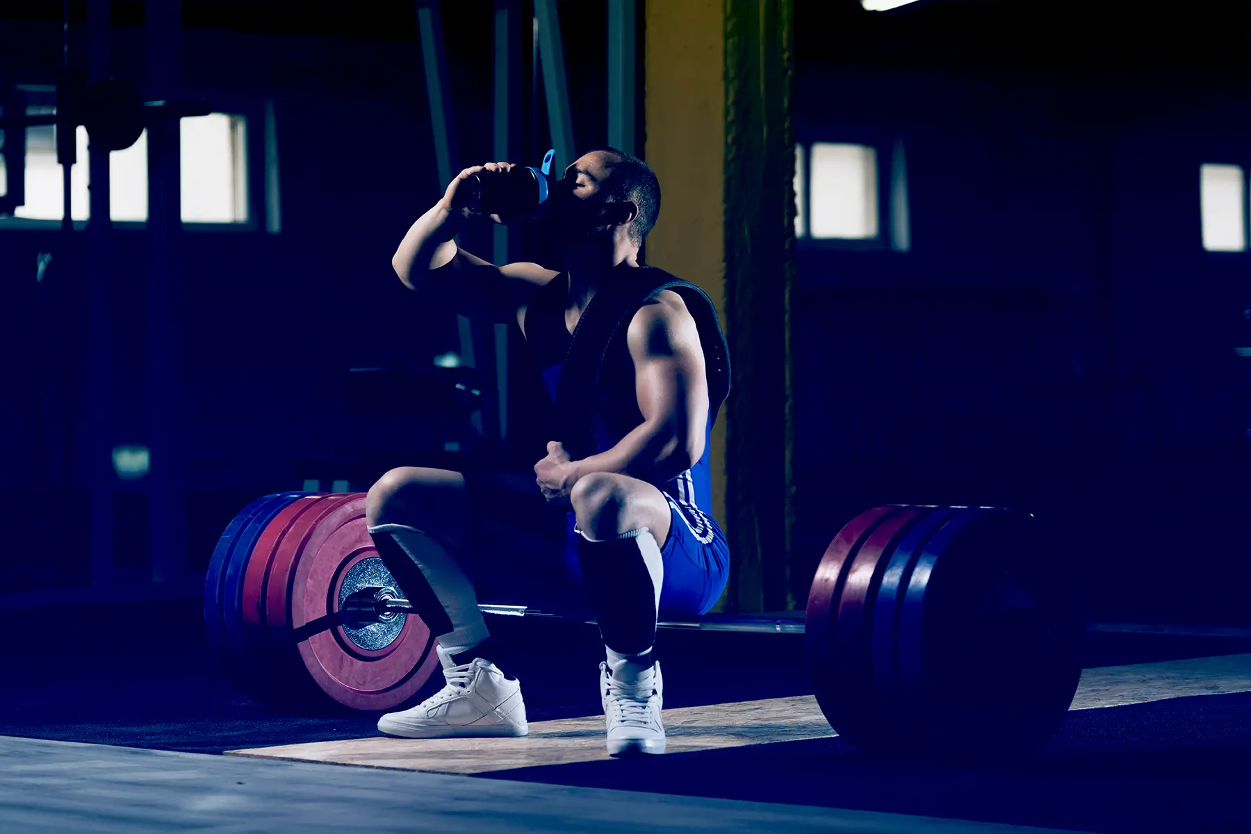 man drinking coffee at gym