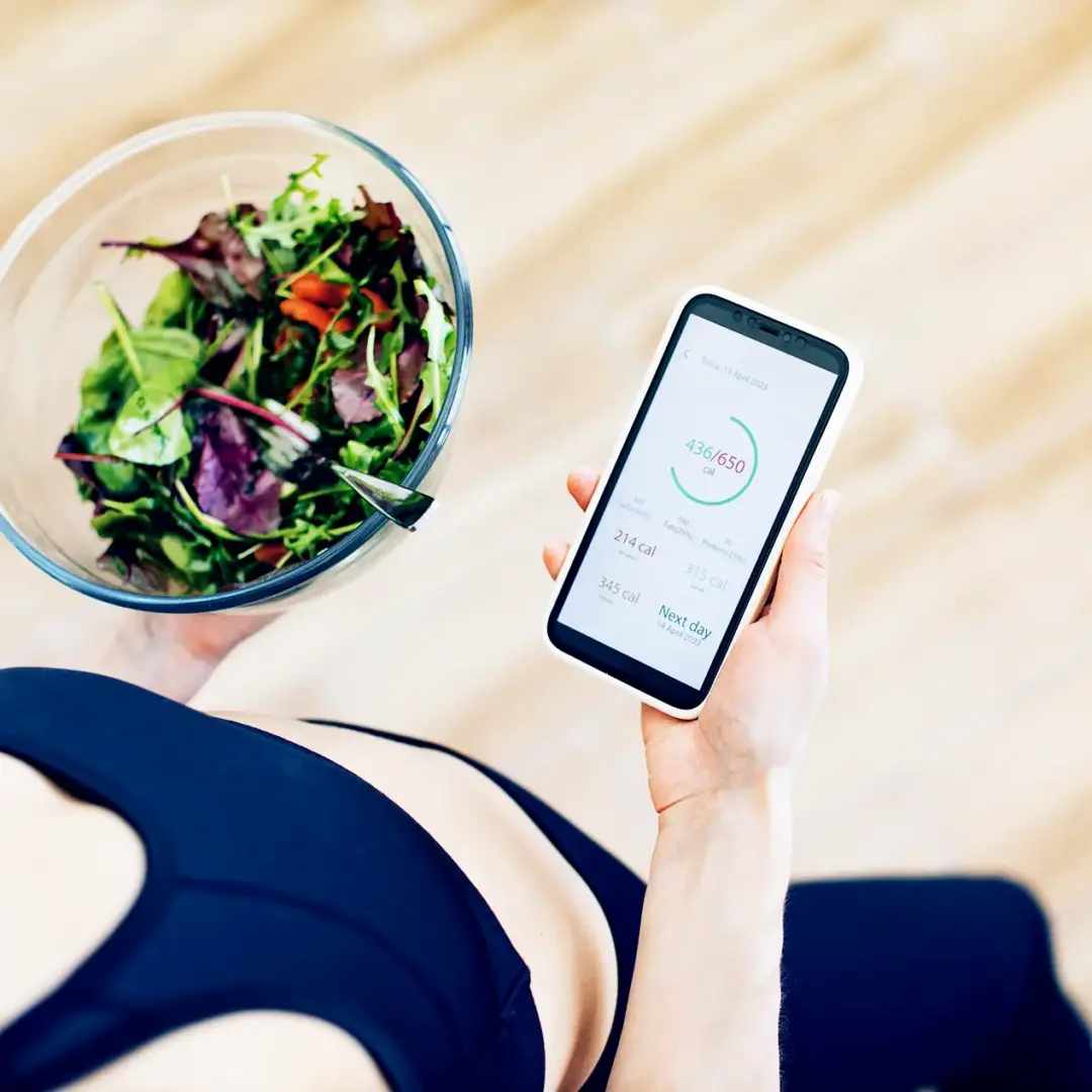 woman tracking calories on her phone