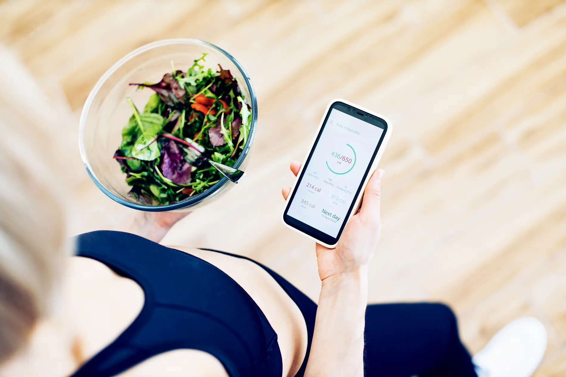 woman tracking calories on her phone