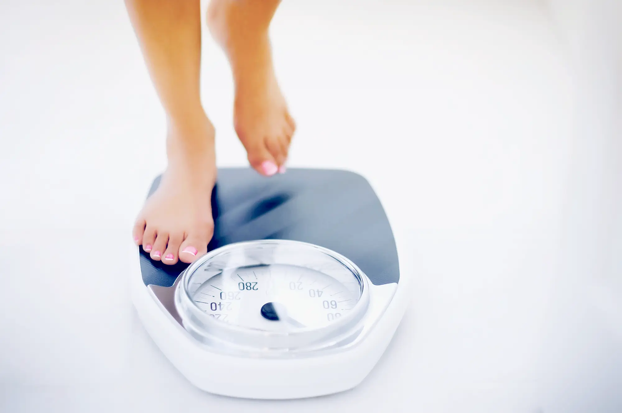 woman stepping on scale