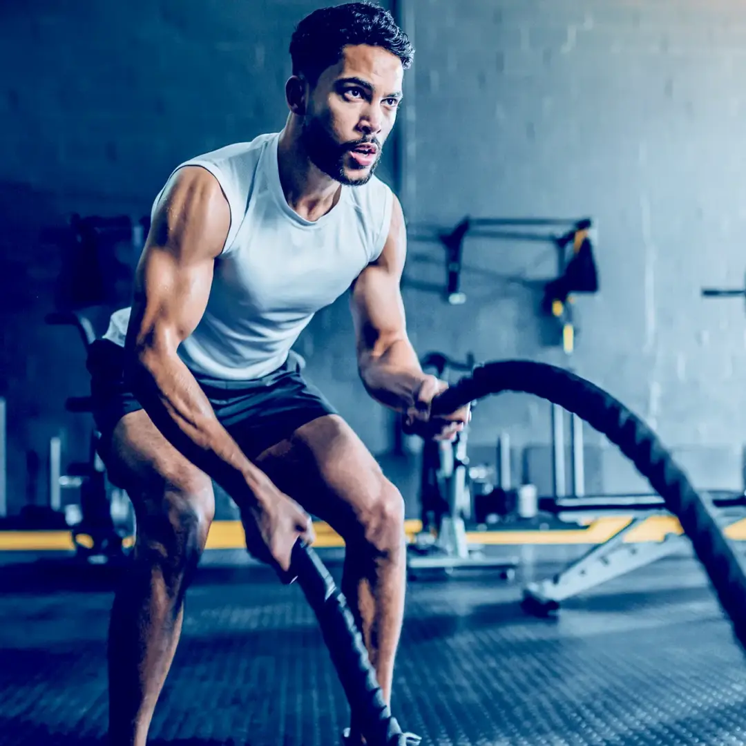 man using battle ropes