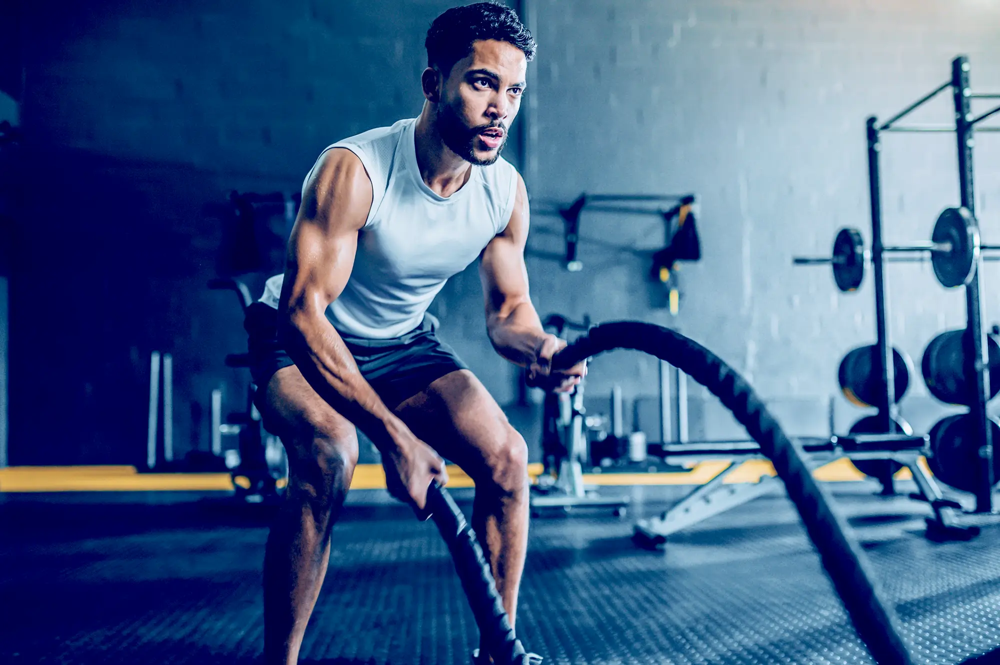man using battle ropes