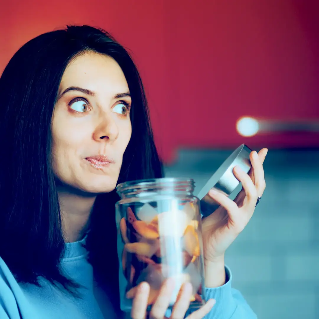 woman with jar making a face