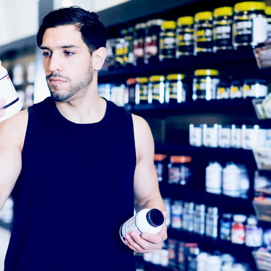 man reading supplement labels