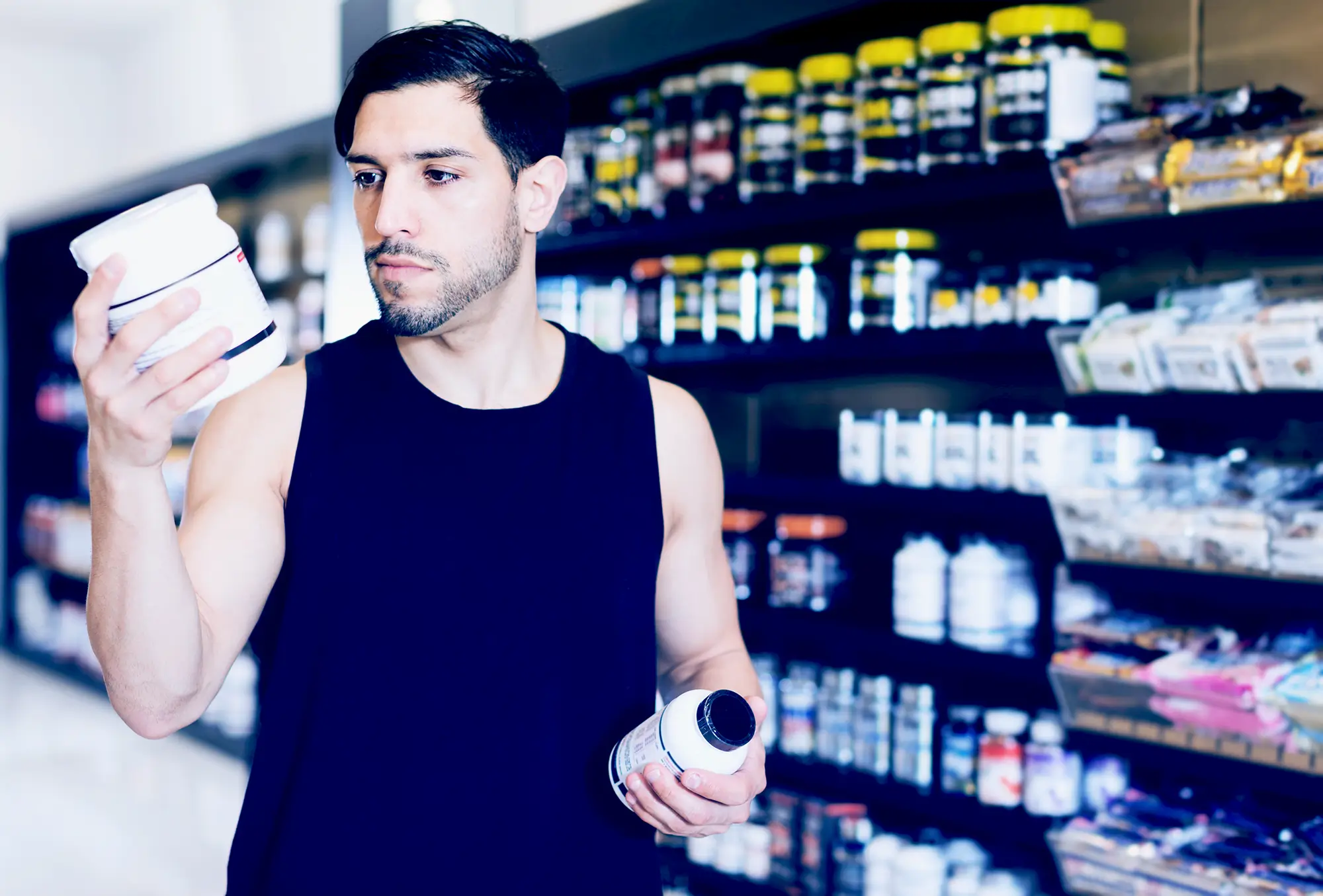 man reading supplement labels