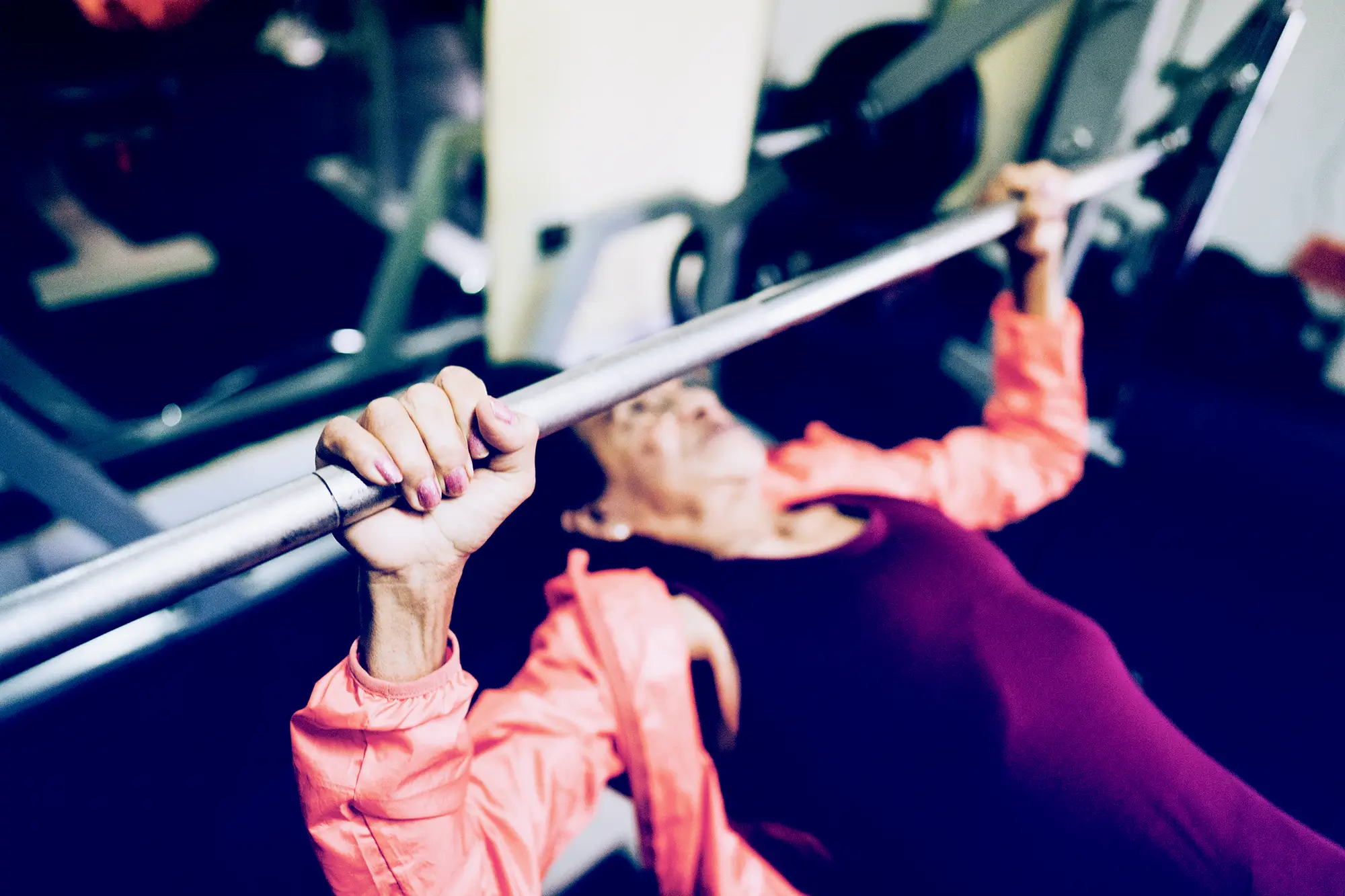 elderly woman doing machine press