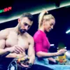 man and woman eating at the gym